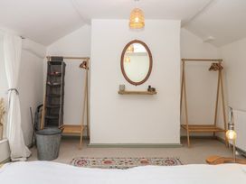 A bedroom with racks and a mirror at Bedford Cottage in Yelverton