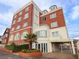 An exterior view of the Union Mill building with a car park and palm tree
