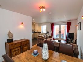 A living room with a dining area and kitchen at Apartment 12 in 
