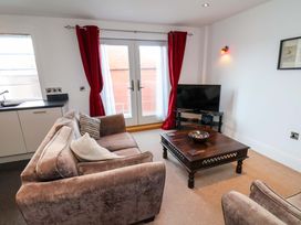 A living room with a sofa and coffee table at Apartment 12 