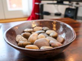 A bowl filled with stones on a table at Apartment 12