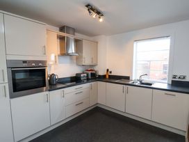 A kitchen with appliances and a sink at Apartment 12 