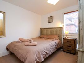 A bedroom with a bed and a nightstand at Apartment 12