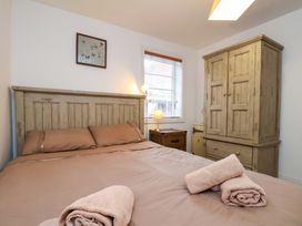 A bedroom with a bed and wardrobe at Apartment 12