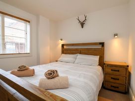 A bedroom with a bed and towels at Apartment 12 in 