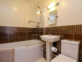 A bathroom with a bathtub, sink and toilet at Apartment 12