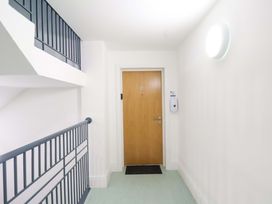 A hallway with a door numbered 12 at Apartment 12 