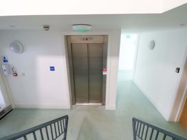 A stairwell with an elevator and wall lights at Apartment 12