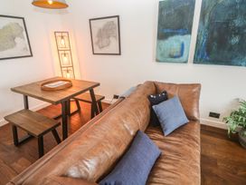 A living room with a sofa and table at Cape View in Cape Cornwall near St Just