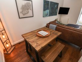 A dining area with a table and benches at Cape View near St Just
