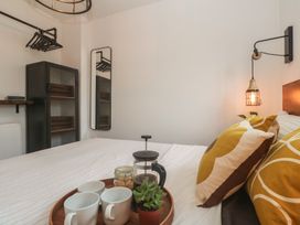 A bedroom with a bed and decorative pillows at Cape View in Cape Cornwall near St Just