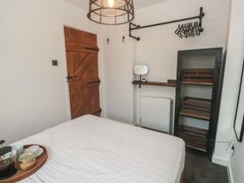 A bedroom with a bed and a storage unit at Cape View in Cape Cornwall near St Just