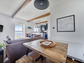 A living room with a sofa and table at Cape View near St Just