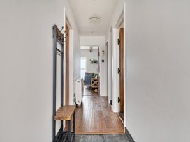 A hallway with a bench and coat rack at Cape View Cape Cornwall near St Just