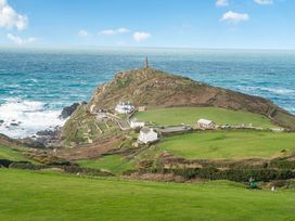 A coastal view with houses and a hill near the ocean at Cape View in Cape Cornwall near St Just