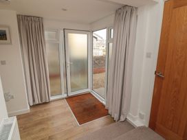 An entrance with a glass door and curtains at 7 Longstone Close Chathill