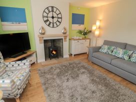 A living room with a sofa and a fireplace at 7 Longstone Close Chathill
