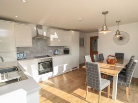A kitchen with a dining area featuring a table and chairs at 7 Longstone Close Chathill