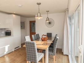 A dining room with a table and chairs at 7 Longstone Close in Chathill