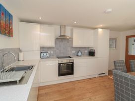 A kitchen with modern appliances and a dining area at 7 Longstone Close in Chathill