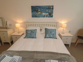 A bedroom with a bed and bedside tables at 7 Longstone Close in Chathill