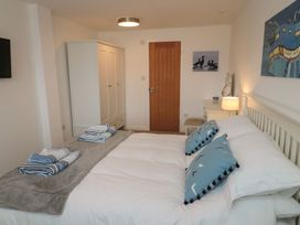 A bedroom with a bed and wardrobe at 7 Longstone Close in Chathill