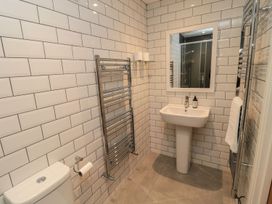 A bathroom with a sink, toilet, and shower at 7 Longstone Close in Chathill