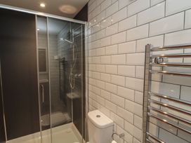 A bathroom with a shower enclosure and toilet at 7 Longstone Close in Chathill