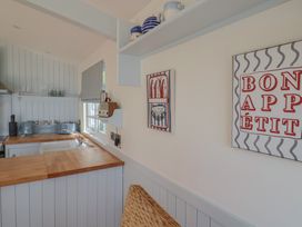 A kitchen with countertop, sink, and wall art at Salt & Stone Lyme Regis