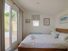 A bedroom with a bed and window at Salt & Stone in Lyme Regis