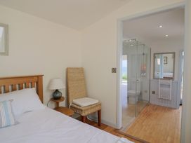 A bedroom with a bed and adjoining bathroom at Salt & Stone in Lyme Regis