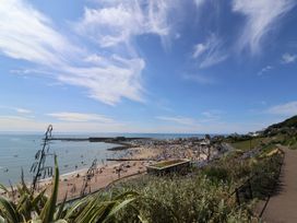 A beach with people near the ocean at Salt & Stone in Lyme Regis