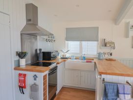 A kitchen with stove, sink, and kettle at Salt & Stone in Lyme Regis
