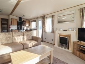A living room with a sofa and coffee table at 23 Gull Court Porthmadog