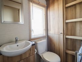 A bathroom with a sink and toilet at 23 Gull Court in Porthmadog