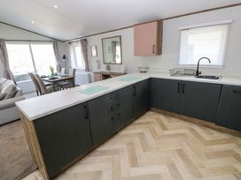 A kitchen with a sink and cabinetry at Dukes Meadow, Carmarthen
