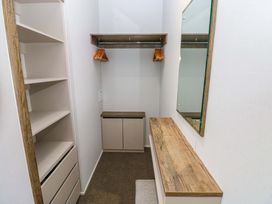 A dressing room with shelves and a mirror at Dukes Meadow in Carmarthen