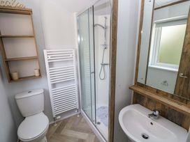 A bathroom with a shower, sink, and toilet at Dukes Meadow in Carmarthen