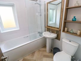 A bathroom featuring a bathtub, sink, and toilet at Dukes Meadow in Carmarthen