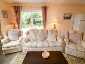 A living room with a sofa and coffee table at Lugdine Lodge in Glengarriff