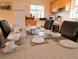 A dining table set with dishes and cutlery at Lugdine Lodge in Glengarriff