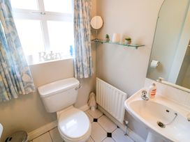 A bathroom with a toilet and sink at Lugdine Lodge in Glengarriff