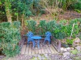 A seating area with blue chairs and a table at Lugdine Lodge Glengarriff