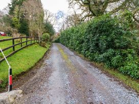 A gravel road surrounded by trees and bushes at Lugdine Lodge in Glengarriff