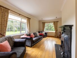 A living room with sofas and a fireplace at Ballyneill Farmhouse in Carrick-On-Suir, County Tipperary