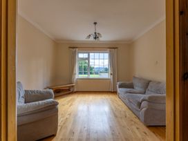 A living room with two sofas and a window at Ballyneill Farmhouse, Carrick-On-Suir, County Tipperary