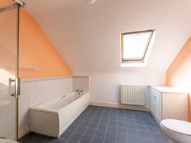 A bathroom with a bathtub and toilet at Ballyneill Farmhouse in Carrick-On-Suir, County Tipperary