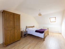 A bedroom with a bed and a wardrobe at Ballyneill Farmhouse, Carrick-On-Suir, County Tipperary