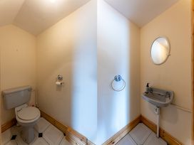 A bathroom with a toilet and sink at Ballyneill Farmhouse, Carrick-On-Suir, County Tipperary
