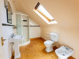 A bathroom featuring a shower, toilet, sink, and bidet at Ballyneill Farmhouse in Carrick-On-Suir, County Tipperary